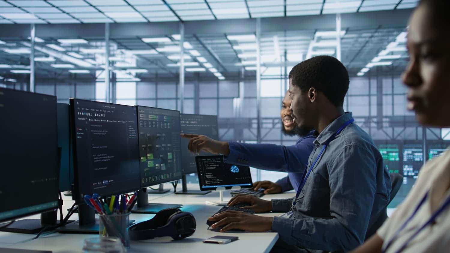 Tecterminal engineers reviewing code together on multiple monitors