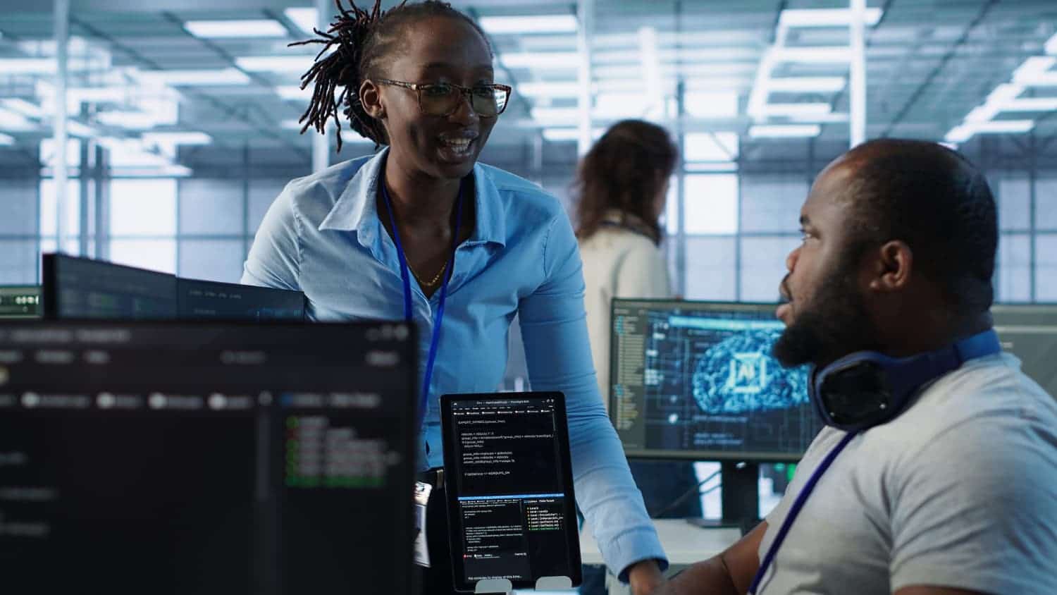 Two Tecterminal engineers collaborating in a modern technology office